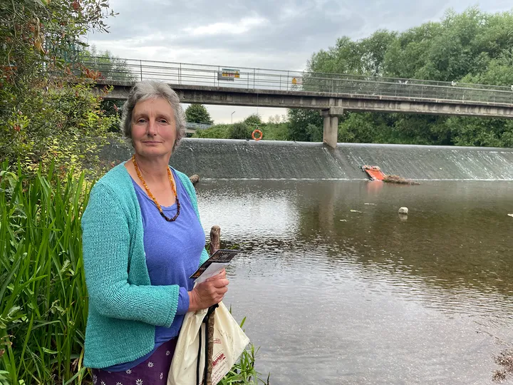 A portrait of Jane Embleton in a blue top and turquoise cardigan at Firepool Weir